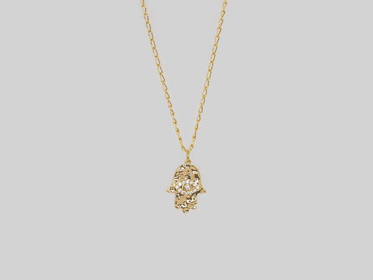 Hand pendant with evil eye in gold plated with zircons Rugged texture. Chain Made Gold Plated 18k Golf plated necklace with zircons. Beautiful handmade necklace. Gold plated chain necklace by Xatli. Gold plated necklace Canada. 18k gold plated chain. Affordable jewelry for every occasion.